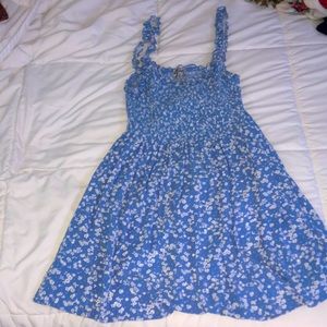 Mid-length, light blue, floral, strapped dress.
